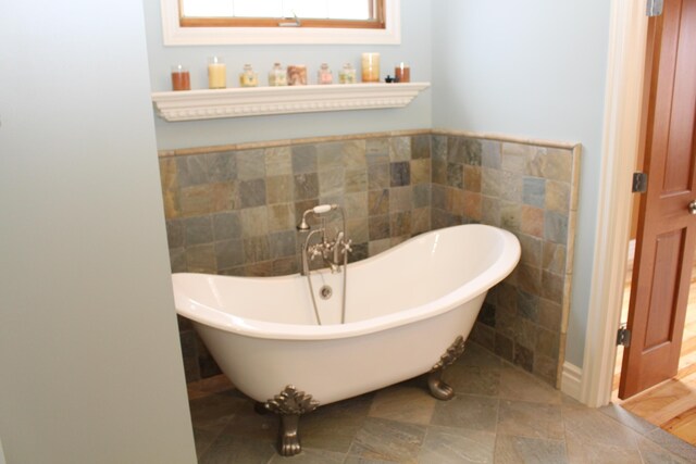 60 Timber Ridge Ct, Milan, MI 48160 - full bathroom featuring a soaking tub and tile walls