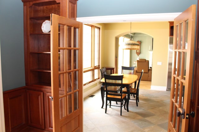 60 Timber Ridge Ct, Milan, MI 48160 - dining room featuring french doors, crown molding, and arched walkways