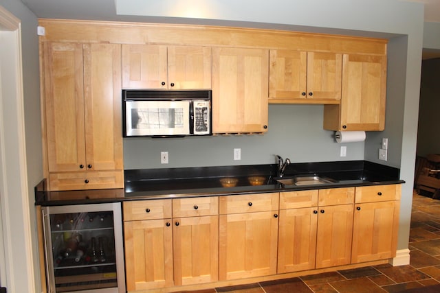 60 Timber Ridge Ct, Milan, MI 48160 - kitchen with stainless steel microwave, beverage cooler, light brown cabinetry, and dark countertops