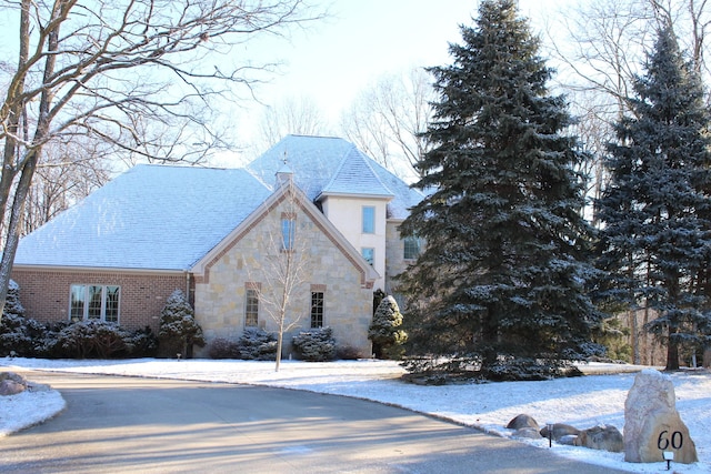 60 Timber Ridge Ct, Milan, MI 48160 - view of snow covered exterior featuring stone siding