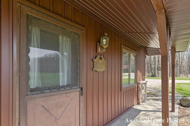 12345 92nd St SE, Alto, MI 49302 - doorway to property with covered porch and board and batten siding