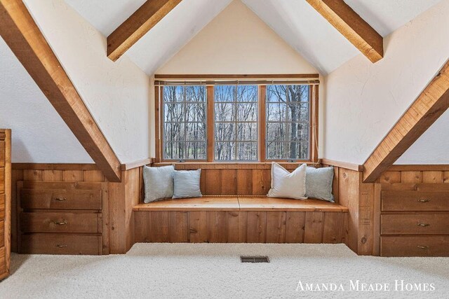 12345 92nd St SE, Alto, MI 49302 - unfurnished room featuring carpet flooring, wood walls, vaulted ceiling with beams, and visible vents