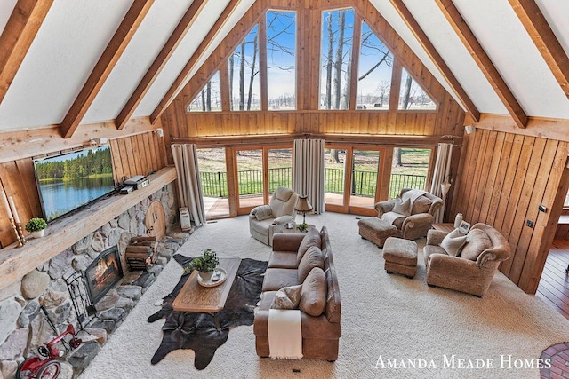 12345 92nd St SE, Alto, MI 49302 - carpeted living room featuring a fireplace, beam ceiling, wooden walls, and high vaulted ceiling