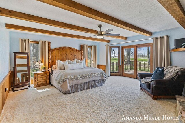 12345 92nd St SE, Alto, MI 49302 - bedroom featuring carpet flooring, beamed ceiling, a wainscoted wall, and access to exterior