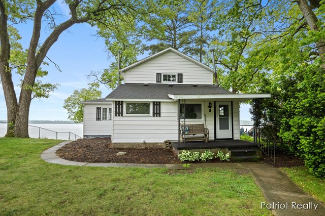 1266 E 88th St, Newaygo, MI 49337 - view of front of house with a porch, a water view, and a shingled roof