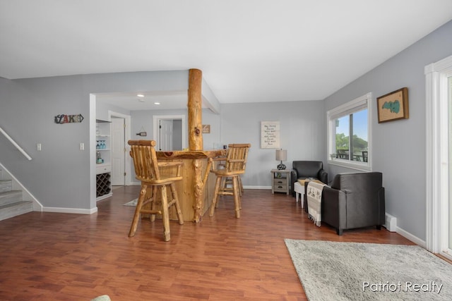 1266 E 88th St, Newaygo, MI 49337 - dining space with stairway, wood finished floors, baseboards, recessed lighting, and bar