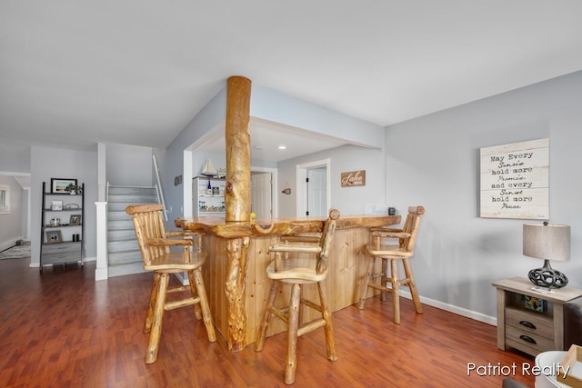 1266 E 88th St, Newaygo, MI 49337 - kitchen with baseboards, wood finished floors, and a breakfast bar