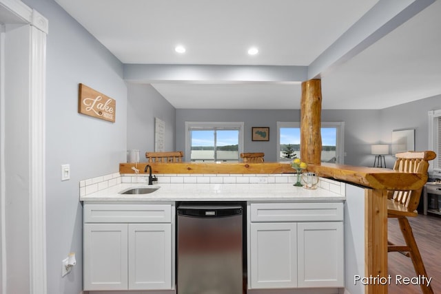 1266 E 88th St, Newaygo, MI 49337 - kitchen featuring stainless steel dishwasher, open floor plan, a sink, white cabinetry, and recessed lighting