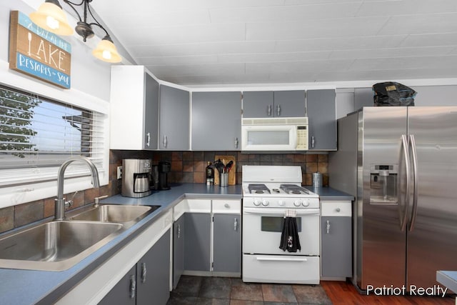 1266 E 88th St, Newaygo, MI 49337 - kitchen featuring white appliances, a sink, gray cabinetry, backsplash, and hanging light fixtures