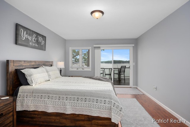 1266 E 88th St, Newaygo, MI 49337 - bedroom with wood finished floors, access to outside, and baseboards