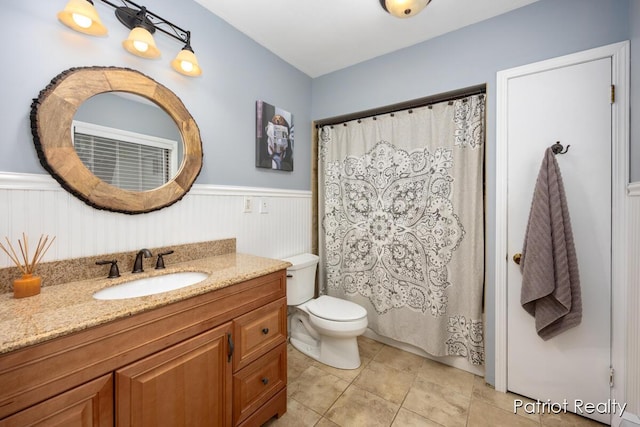 1266 E 88th St, Newaygo, MI 49337 - full bath with wainscoting, vanity, toilet, tile patterned floors, and a shower with curtain