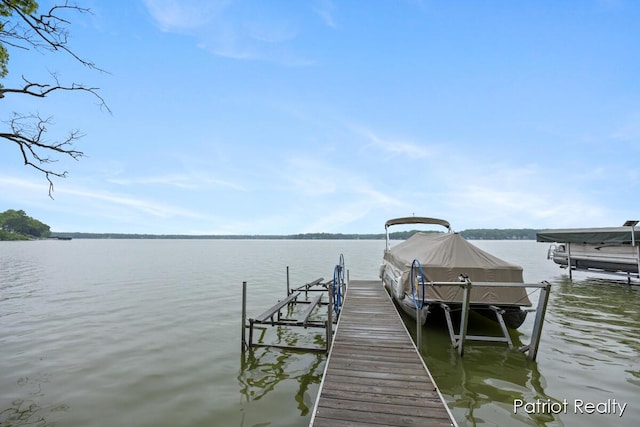 1266 E 88th St, Newaygo, MI 49337 - dock featuring a water view and boat lift