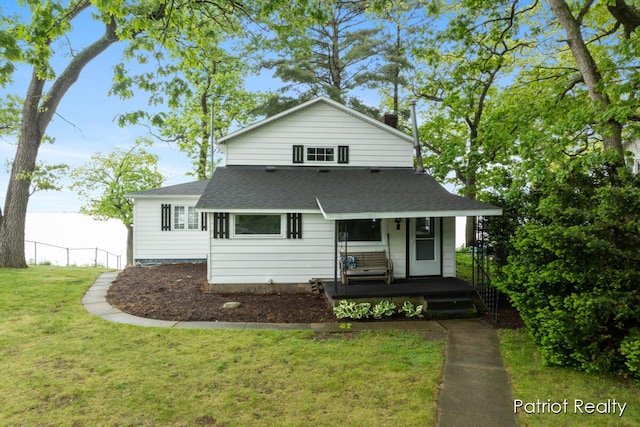 1266 E 88th St, Newaygo, MI 49337 - view of front facade with a porch, roof with shingles, and a front lawn