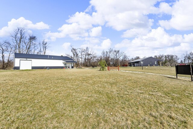 7499 Mathews Rd, Spring Arbor, MI 49283 - view of yard with a garage