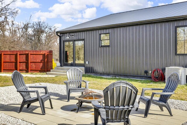7499 Mathews Rd, Spring Arbor, MI 49283 - view of patio / terrace featuring central air condition unit, fence, and an outdoor fire pit