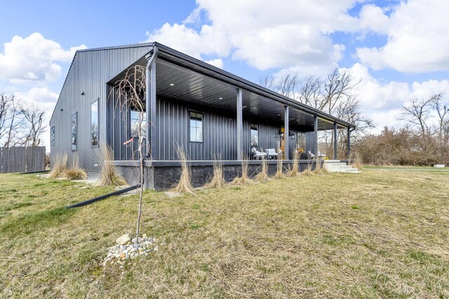 7499 Mathews Rd, Spring Arbor, MI 49283 - view of home's exterior featuring a lawn, fence, and board and batten siding