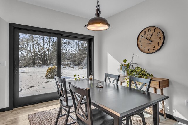 7499 Mathews Rd, Spring Arbor, MI 49283 - dining area with baseboards and light wood-style flooring