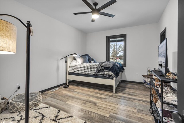 7499 Mathews Rd, Spring Arbor, MI 49283 - bedroom featuring ceiling fan, baseboards, visible vents, and wood finished floors