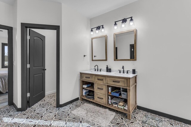 7499 Mathews Rd, Spring Arbor, MI 49283 - bathroom featuring a sink, baseboards, tile patterned flooring, and double vanity