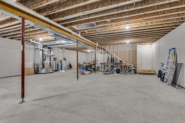 7499 Mathews Rd, Spring Arbor, MI 49283 - unfinished below grade area with heating unit and gas water heater