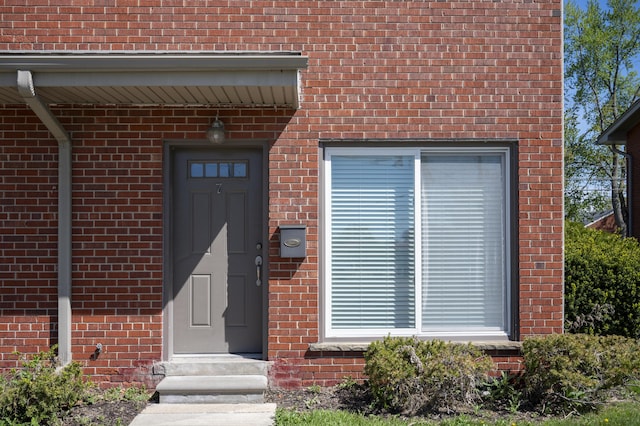property entrance with brick siding