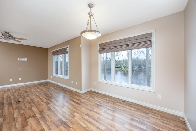 18559 Kreig Dr, Big Rapids, MI 49307 - empty room featuring ceiling fan, baseboards, visible vents, and light wood-style flooring