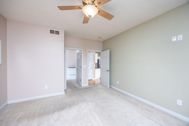 18559 Kreig Dr, Big Rapids, MI 49307 - unfurnished bedroom featuring baseboards, a ceiling fan, visible vents, and light carpet
