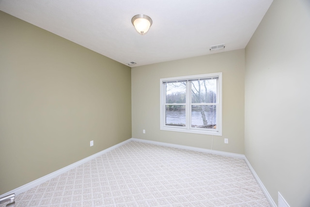 18559 Kreig Dr, Big Rapids, MI 49307 - spare room featuring visible vents, baseboards, and light carpet