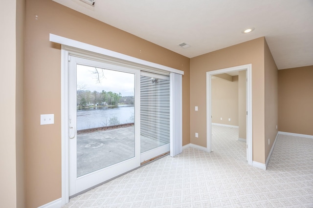 18559 Kreig Dr, Big Rapids, MI 49307 - interior space with visible vents, light colored carpet, baseboards, a water view, and recessed lighting