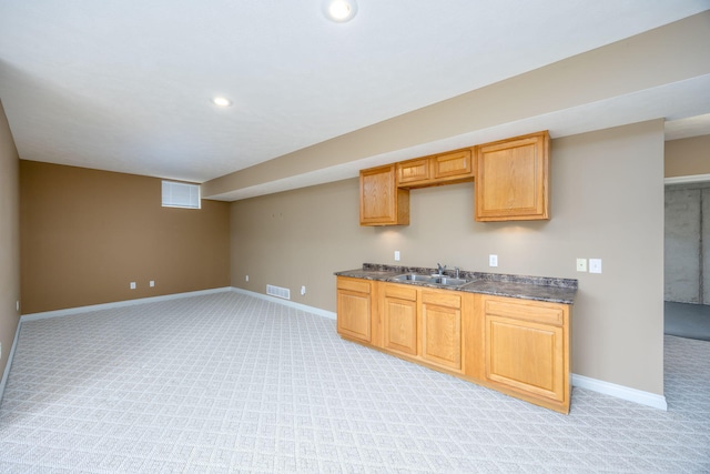 18559 Kreig Dr, Big Rapids, MI 49307 - kitchen featuring dark countertops, light carpet, and visible vents