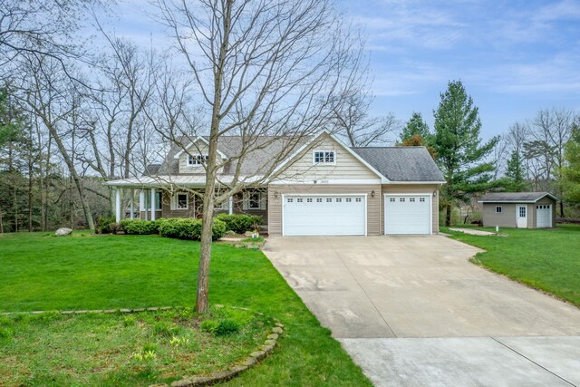 18559 Kreig Dr, Big Rapids, MI 49307 - view of front of home with covered porch, driveway, an outdoor structure, a front lawn, and an attached garage