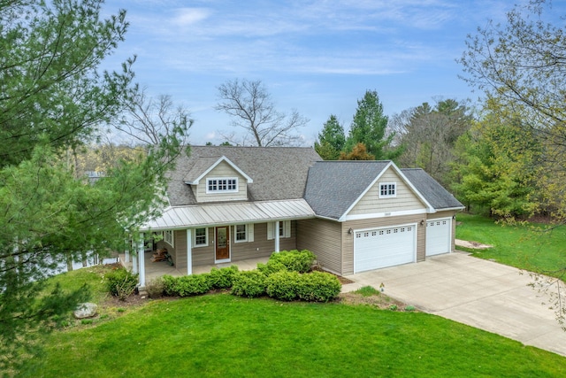 18559 Kreig Dr, Big Rapids, MI 49307 - view of front of property featuring an attached garage, a front yard, covered porch, driveway, and metal roof