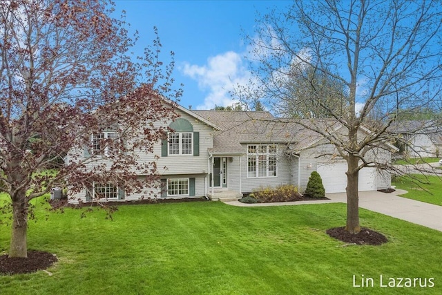 6332 Rush Creek Ct, Hudsonville, MI 49426 - split level home featuring a garage, a shingled roof, concrete driveway, and a front yard