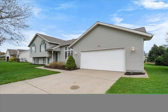 6332 Rush Creek Ct, Hudsonville, MI 49426 - tri-level home featuring an attached garage, a front yard, and concrete driveway