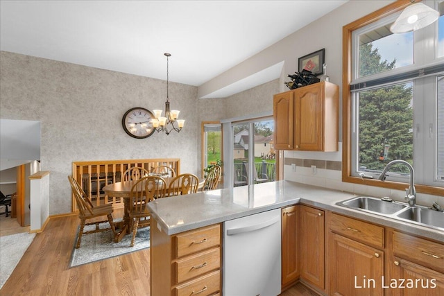 6332 Rush Creek Ct, Hudsonville, MI 49426 - kitchen featuring a peninsula, light wood-style floors, light countertops, a sink, and dishwasher