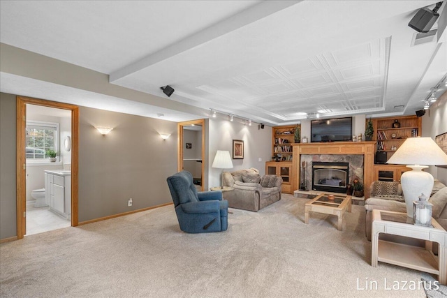 6332 Rush Creek Ct, Hudsonville, MI 49426 - living area featuring a high end fireplace, rail lighting, baseboards, and light carpet