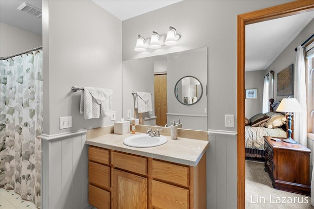 6332 Rush Creek Ct, Hudsonville, MI 49426 - bathroom featuring connected bathroom, vanity, a shower with shower curtain, a wainscoted wall, and visible vents