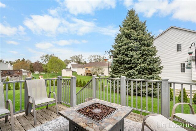 6332 Rush Creek Ct, Hudsonville, MI 49426 - deck with a storage unit, an outdoor structure, a yard, and a residential view