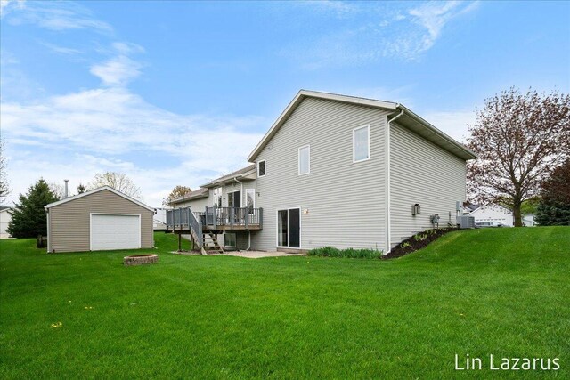 6332 Rush Creek Ct, Hudsonville, MI 49426 - back of house with a wooden deck, a garage, an outdoor structure, an outdoor fire pit, and a yard