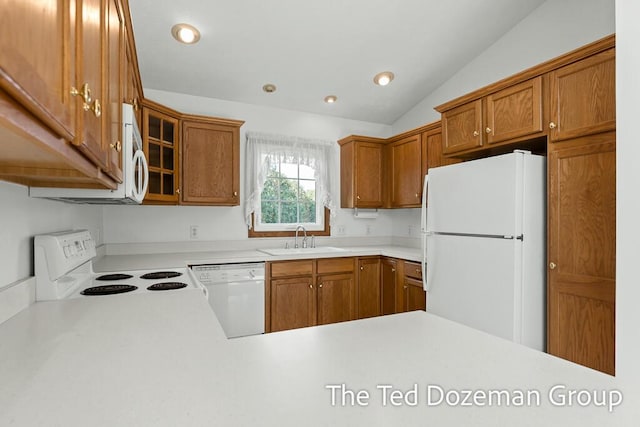 45 Trillium Ct, Holland, MI 49423 - kitchen featuring vaulted ceiling, brown cabinets, a sink, light countertops, and white appliances