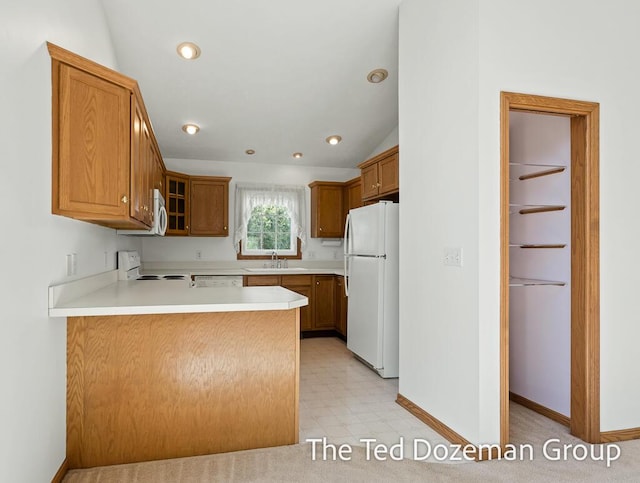 45 Trillium Ct, Holland, MI 49423 - kitchen featuring a sink, a peninsula, glass insert cabinets, light floors, and white appliances