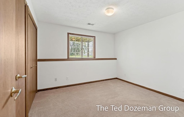 45 Trillium Ct, Holland, MI 49423 - unfurnished bedroom with baseboards, visible vents, light carpet, and a closet