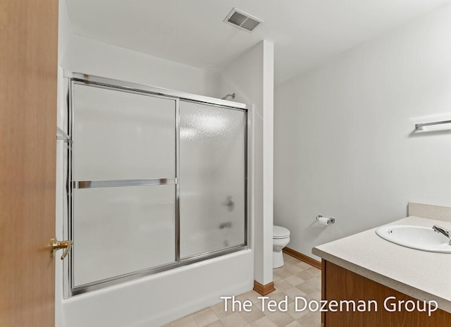 45 Trillium Ct, Holland, MI 49423 - full bath with vanity, toilet, enclosed tub / shower combo, baseboards, and visible vents