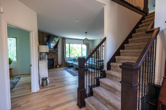 270 Fairway View Dr, Oxford, MI 48371 - stairs featuring wood finished floors and a stone fireplace