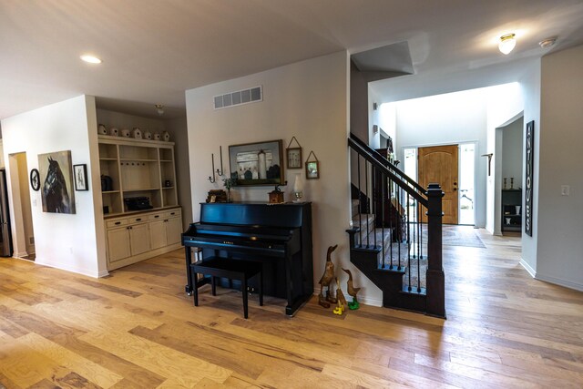 270 Fairway View Dr, Oxford, MI 48371 - hallway with light wood finished floors, stairs, and recessed lighting