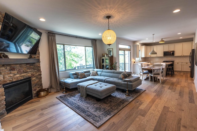 270 Fairway View Dr, Oxford, MI 48371 - living room featuring light wood-style floors, a fireplace, recessed lighting, and a chandelier