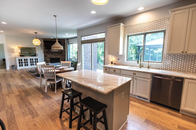 270 Fairway View Dr, Oxford, MI 48371 - kitchen featuring dishwasher, light wood-style flooring, decorative backsplash, light stone countertops, and recessed lighting