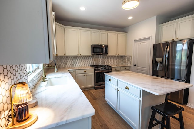 270 Fairway View Dr, Oxford, MI 48371 - kitchen with appliances with stainless steel finishes, tasteful backsplash, dark wood-type flooring, a kitchen island, and recessed lighting
