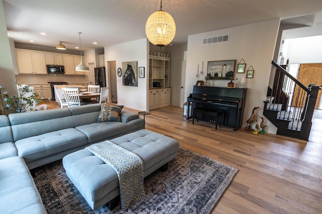 270 Fairway View Dr, Oxford, MI 48371 - living room with a chandelier, light wood finished floors, stairway, and recessed lighting