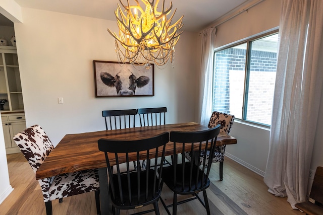 270 Fairway View Dr, Oxford, MI 48371 - dining area featuring a chandelier, light wood-style floors, and healthy amount of natural light